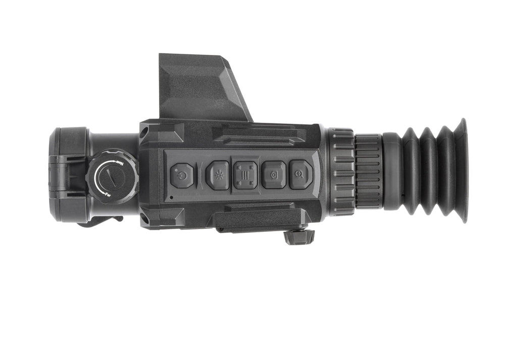 A thermal scope with a black polymer frame and red reticle, mounted on a rifle, showing heat signatures of targets in a woodl