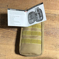 Birchwood Casey Rifle and Handgun Range Cleaning Kit on a wooden surface, showing a tan carrying case and instruction booklet